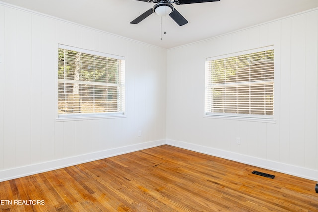 spare room featuring ornamental molding, ceiling fan, and hardwood / wood-style flooring