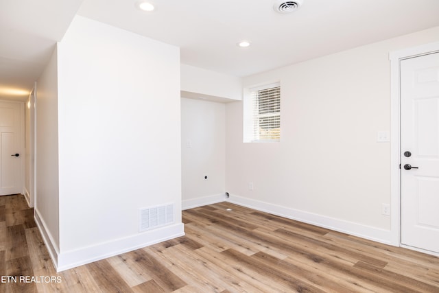 unfurnished room with light wood-type flooring