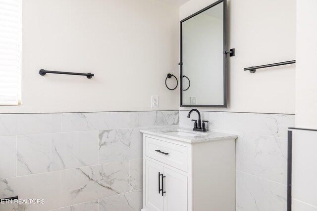 bathroom featuring tile walls and vanity