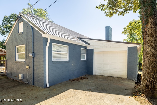 view of side of home with a garage