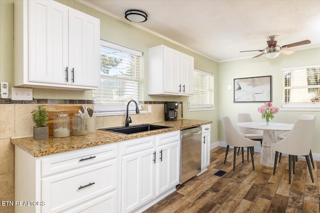 kitchen featuring stainless steel dishwasher, a wealth of natural light, dark hardwood / wood-style floors, and white cabinets