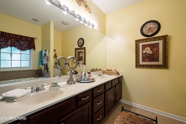 bathroom with tile patterned floors, vanity, and a bathing tub