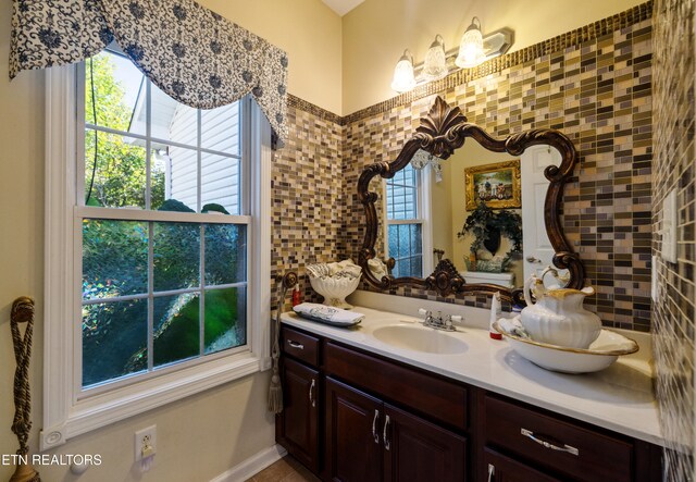 bathroom featuring a healthy amount of sunlight and vanity