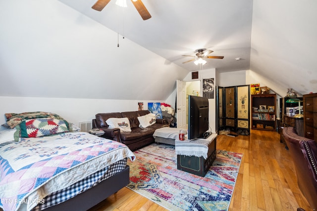 bedroom with vaulted ceiling, hardwood / wood-style floors, and ceiling fan