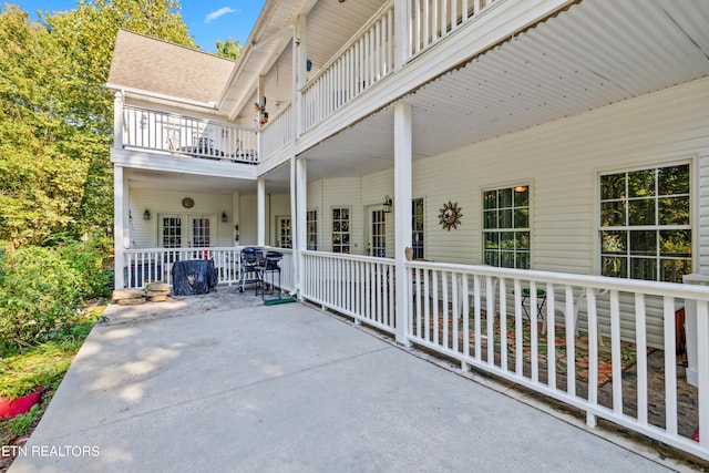 view of patio with a balcony and covered porch