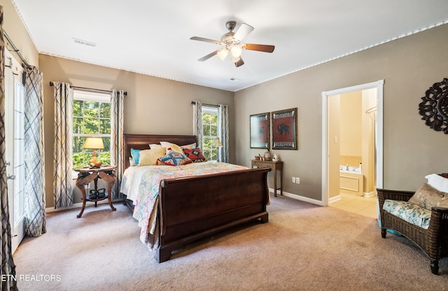 carpeted bedroom with ceiling fan and connected bathroom