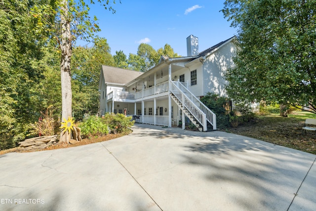 back of house featuring a porch