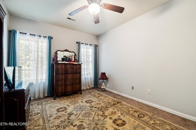 bedroom featuring carpet flooring, multiple windows, and ceiling fan