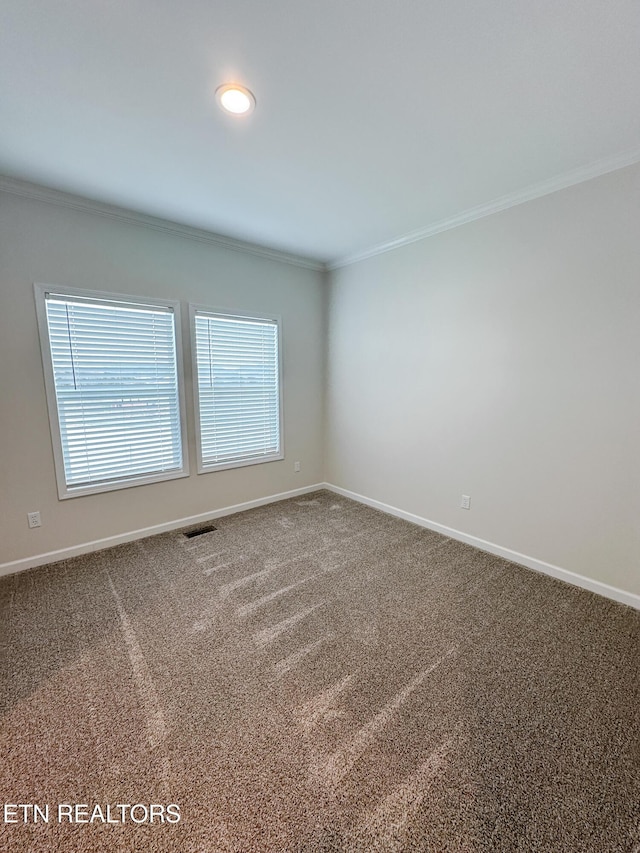 carpeted spare room with crown molding