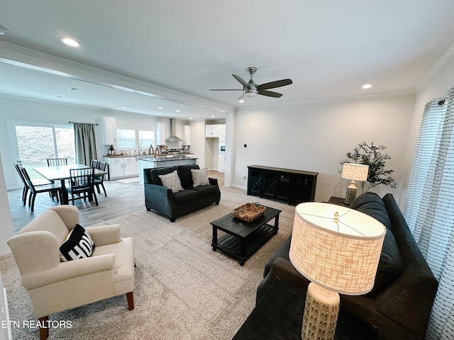 living room featuring ornamental molding and ceiling fan