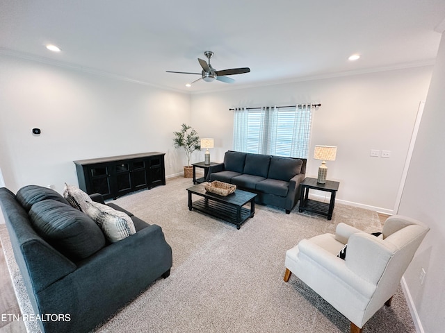 carpeted living room featuring ornamental molding and ceiling fan