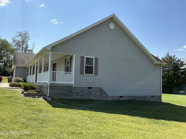 view of side of property with a lawn