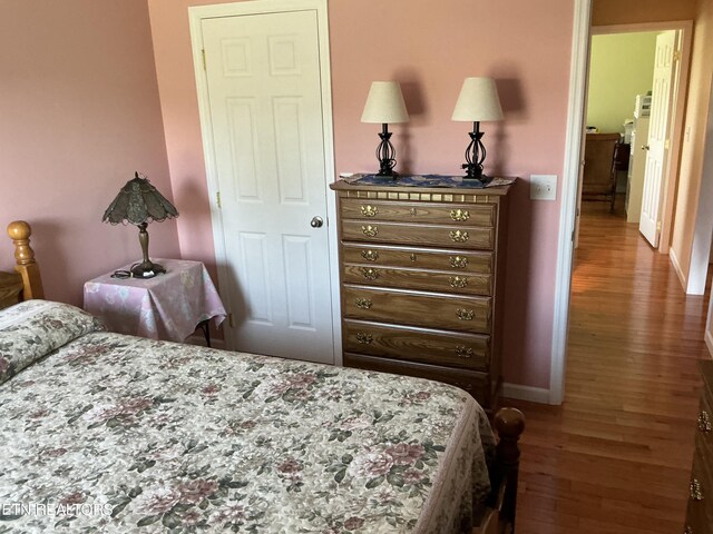 bedroom with hardwood / wood-style flooring