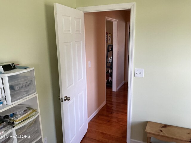 corridor featuring dark wood-type flooring