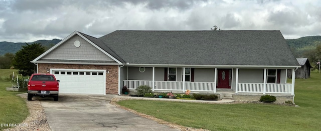 view of front facade featuring a front yard, a mountain view, and covered porch