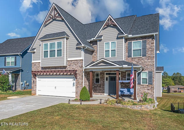 view of front of house featuring a front lawn, a garage, and a porch