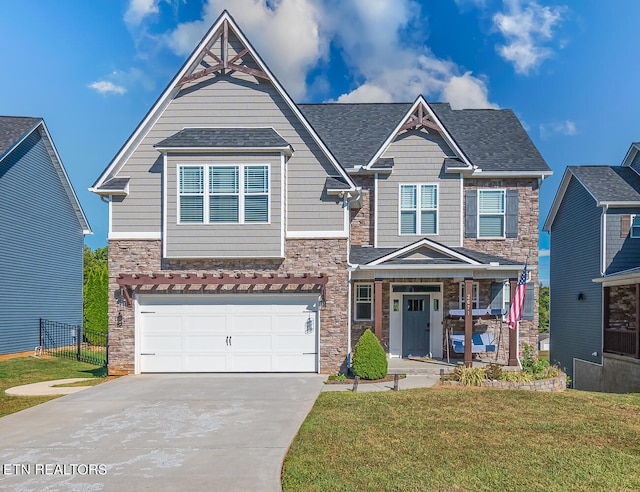 craftsman-style home featuring a front lawn, a garage, and covered porch