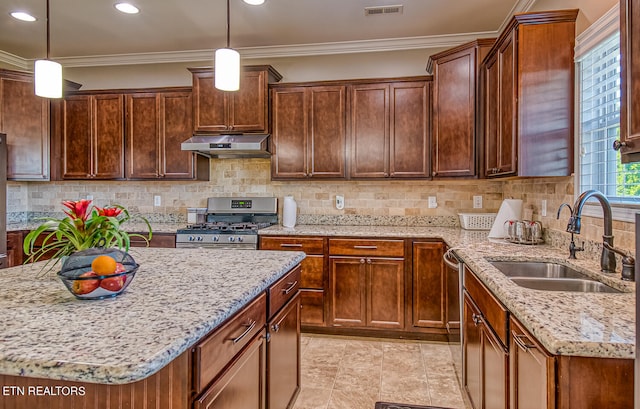 kitchen featuring pendant lighting, sink, ornamental molding, and stainless steel appliances