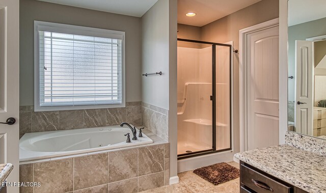 bathroom with independent shower and bath, plenty of natural light, and tile patterned floors