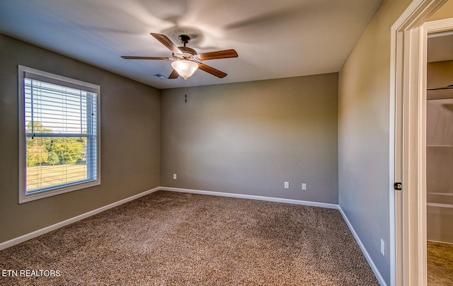 unfurnished room with ceiling fan and carpet floors