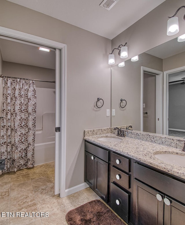 bathroom with vanity, tile patterned flooring, and shower / bath combo with shower curtain