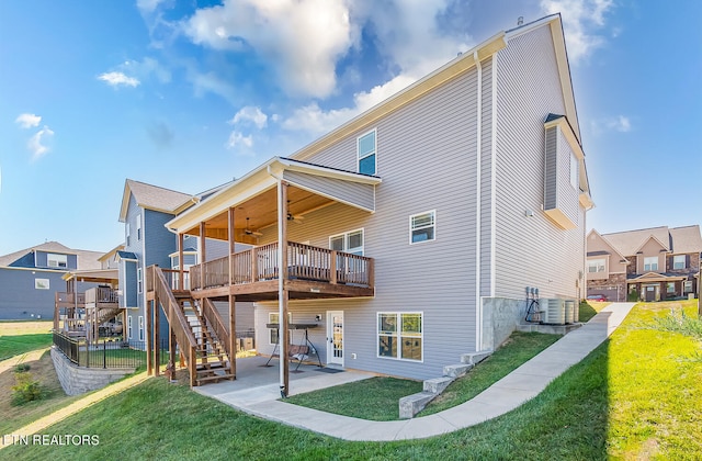 back of house featuring central AC unit, a lawn, a patio, and a deck