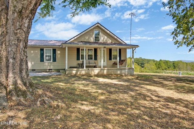 view of front facade with covered porch and a front yard