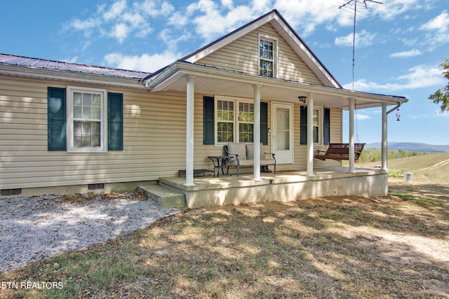 view of front of house featuring a mountain view and a porch