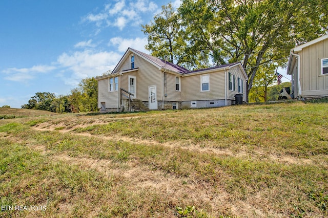 back of property featuring a yard