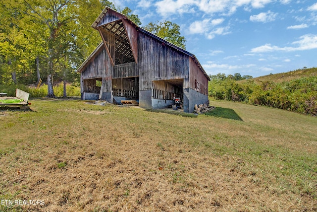 view of outbuilding with a lawn