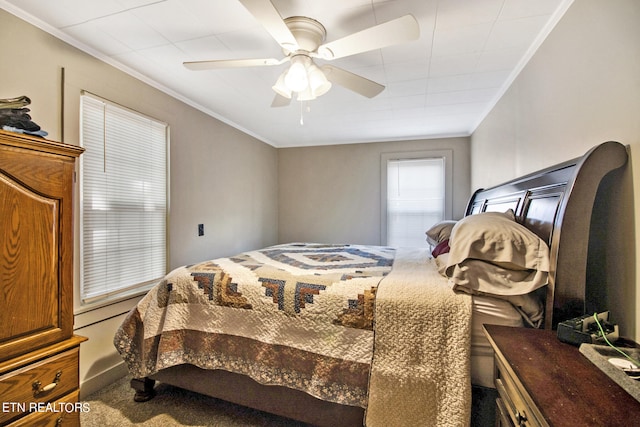 bedroom with ornamental molding and ceiling fan