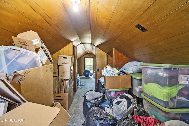 additional living space featuring vaulted ceiling, wood walls, wooden ceiling, and carpet floors