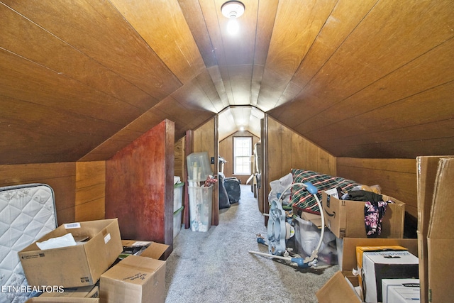 bonus room featuring wooden ceiling, lofted ceiling, wood walls, and light carpet