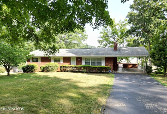 single story home with a front lawn and a carport