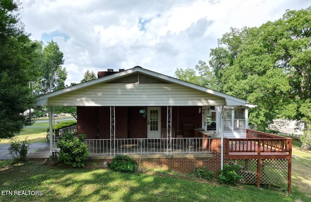 view of front of property with covered porch and a front yard