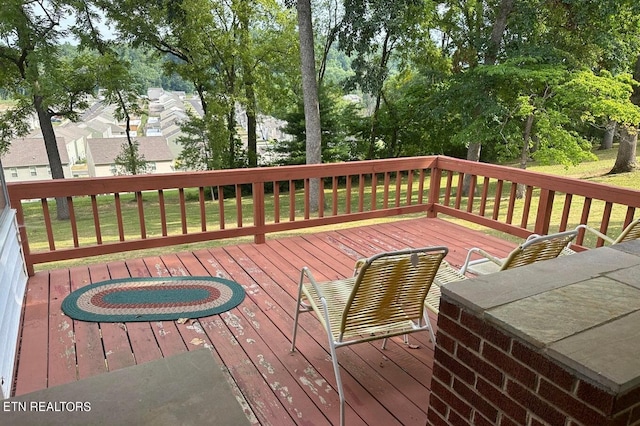 wooden deck with a lawn