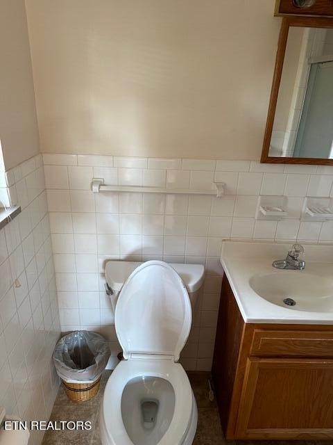 bathroom with vanity, tile walls, toilet, and decorative backsplash