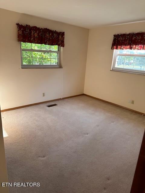 spare room featuring carpet