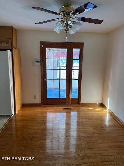 spare room featuring ceiling fan and light hardwood / wood-style flooring