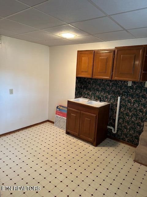 kitchen with a drop ceiling and sink