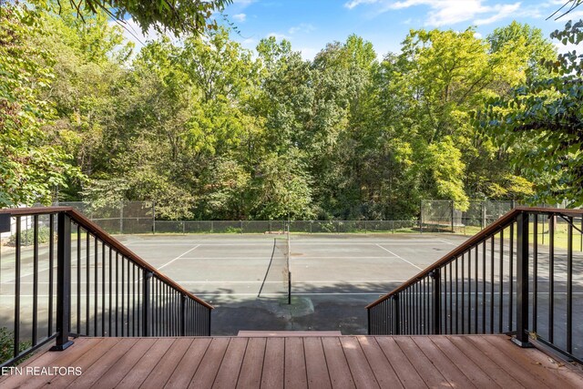 wooden deck with tennis court