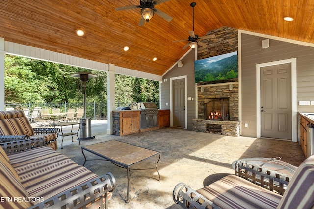 view of patio featuring ceiling fan, an outdoor stone fireplace, and an outdoor kitchen