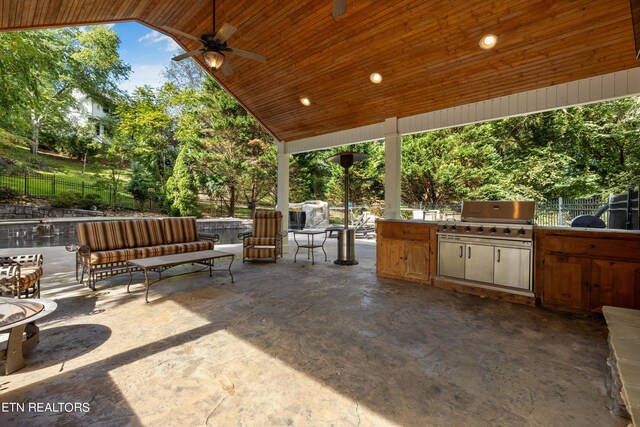 view of patio featuring an outdoor living space, ceiling fan, a grill, and an outdoor kitchen