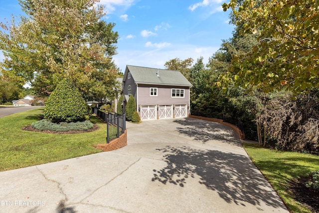 view of front of property with a garage and a front lawn