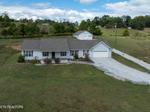 single story home featuring a front yard and a garage