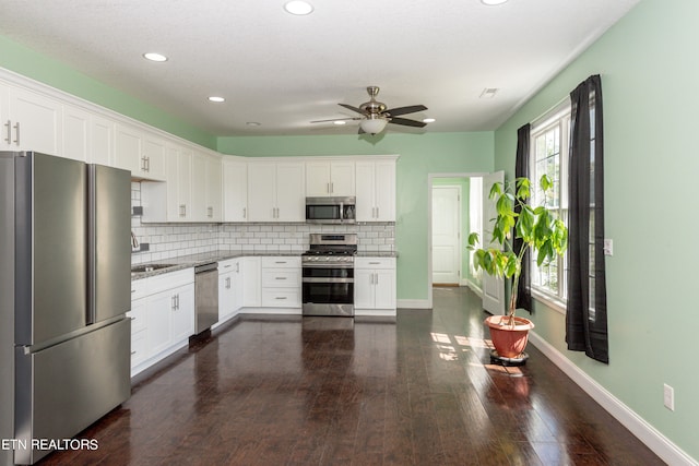 kitchen featuring dark hardwood / wood-style floors, sink, white cabinets, stainless steel appliances, and ceiling fan