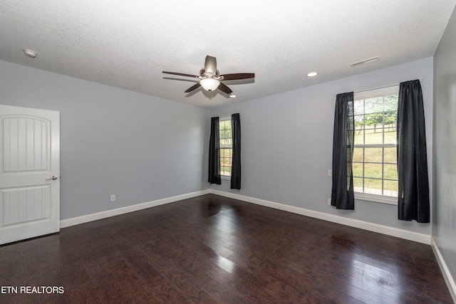 spare room featuring ceiling fan, a textured ceiling, and dark wood-type flooring