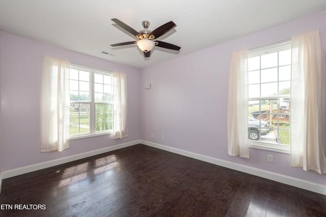 unfurnished room featuring ceiling fan and dark hardwood / wood-style floors