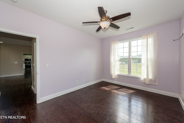 unfurnished room featuring dark hardwood / wood-style floors and ceiling fan