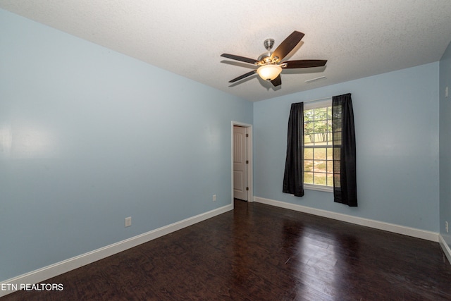 spare room featuring ceiling fan, a textured ceiling, and dark hardwood / wood-style flooring